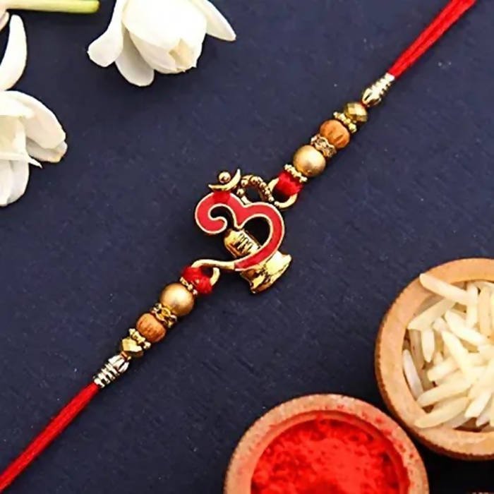 Auspicious Om Pearl Rakhi & Cadbury Fruit N Nut