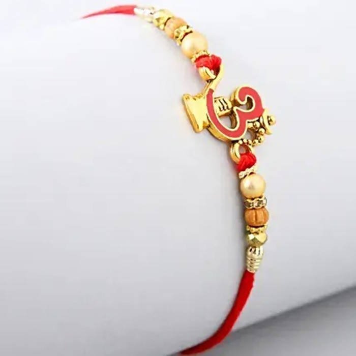 Auspicious Om Pearl Rakhi & Cadbury Fruit N Nut