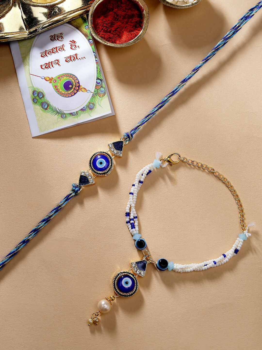 NVR Women & Men Set of 2 Blue Evil Eye Bhaiya Bhabhi Rakhi With Roli Chawal & Chocolate