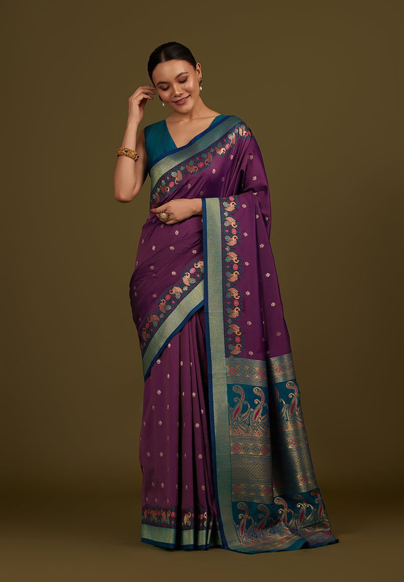 Monjolika Fashion Dark Purple Banarasi Silk Blend SareeIn Classic Paisley & Rich Zari Pallu Comes With Unstitched Blouse