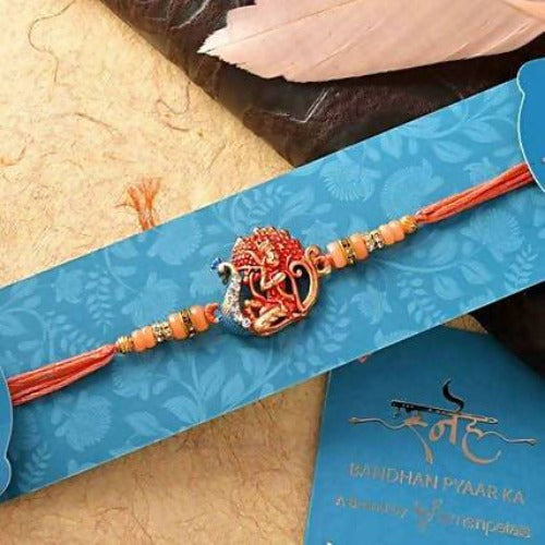 Krishna Raag Rakhi & Chocolate Dipped Khajoor Laddu Combo