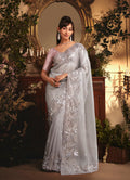 Monjolika Fashion Designer Light Grey Tissue Organza Saree With All Over Butta Work & Heavy Stone Embellished Border