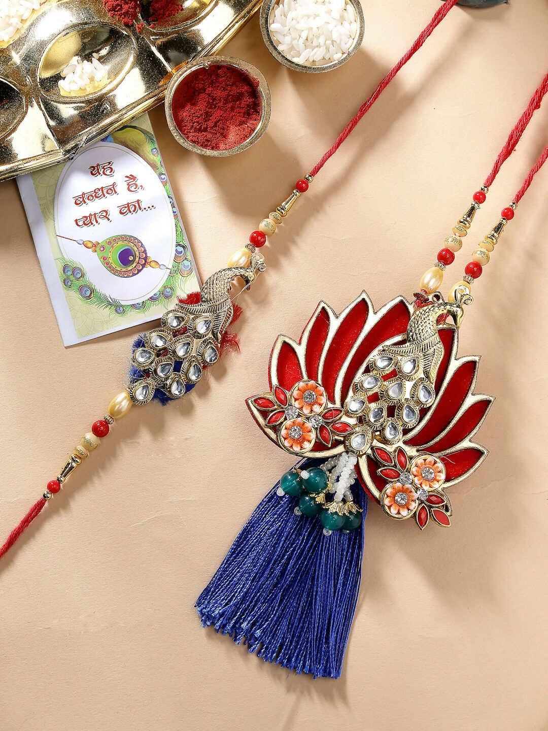 NVR Women & Men Set of 2 Gold-Toned Peacock Design Stone-Studded Bhaiya Bhabhi Rakhi With Roli Chawal