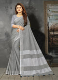 Shree Shyam Fashion Elegant Light Grey Woven Linen Saree with Contrast Zari Border & Tassels - Soft & Breathable Party Wear