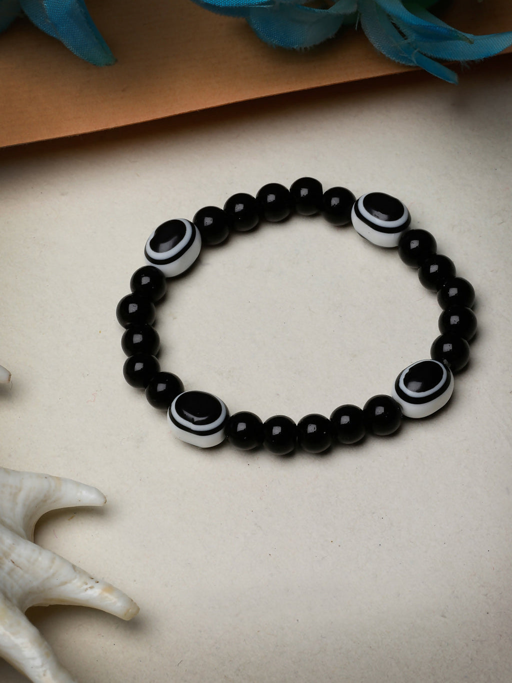 NVR Women & Men Black Evil Eye Elasticated Rakhi With Roli Chawal