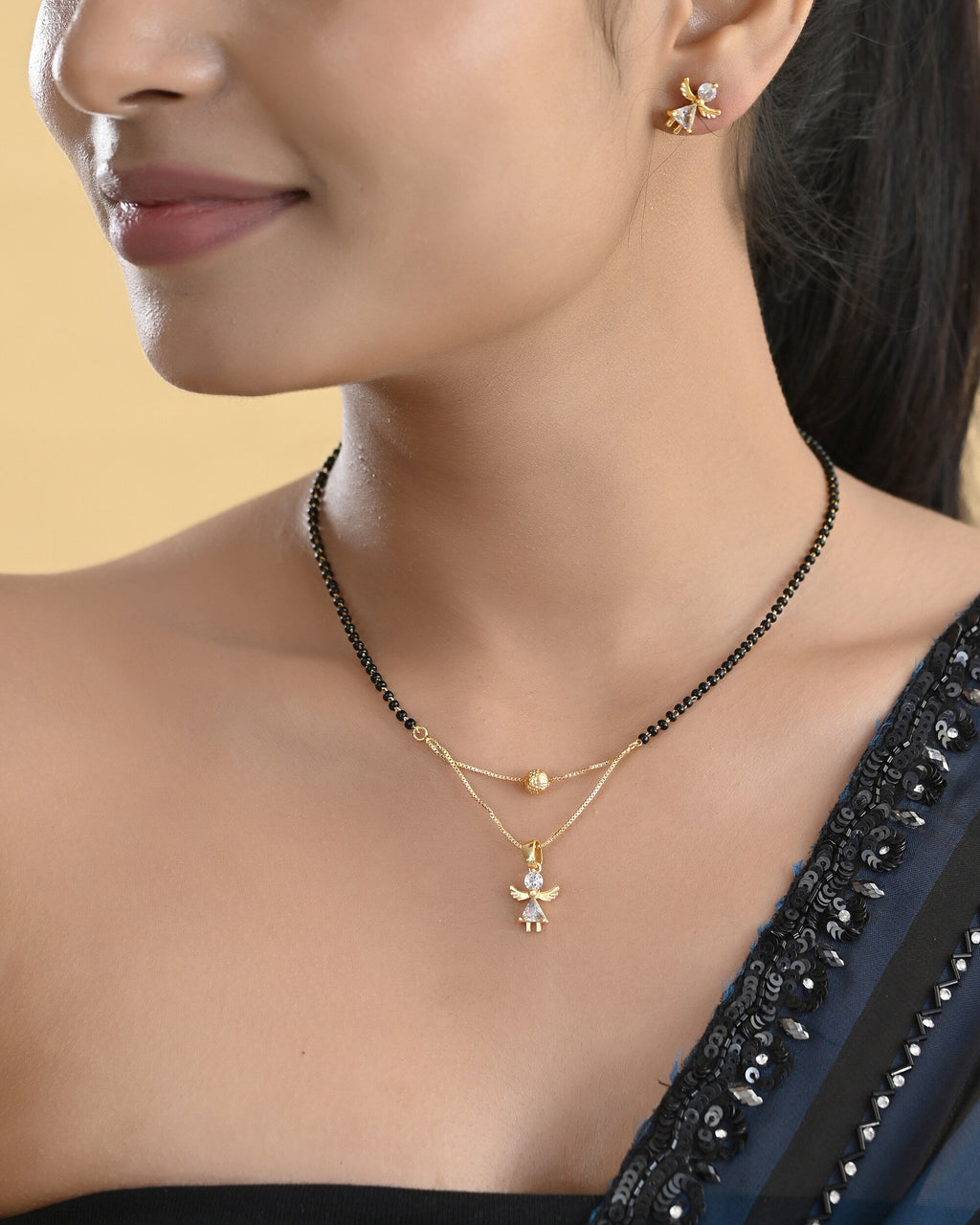 VOJ Gold-Polished Doll Shapped Stone Studded Mangalsutra With Earrings Set
