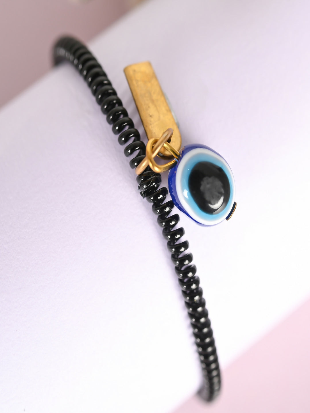 NVR Women & Men Black Evil Eye Spring Ring Rakhi With Roli Chawal