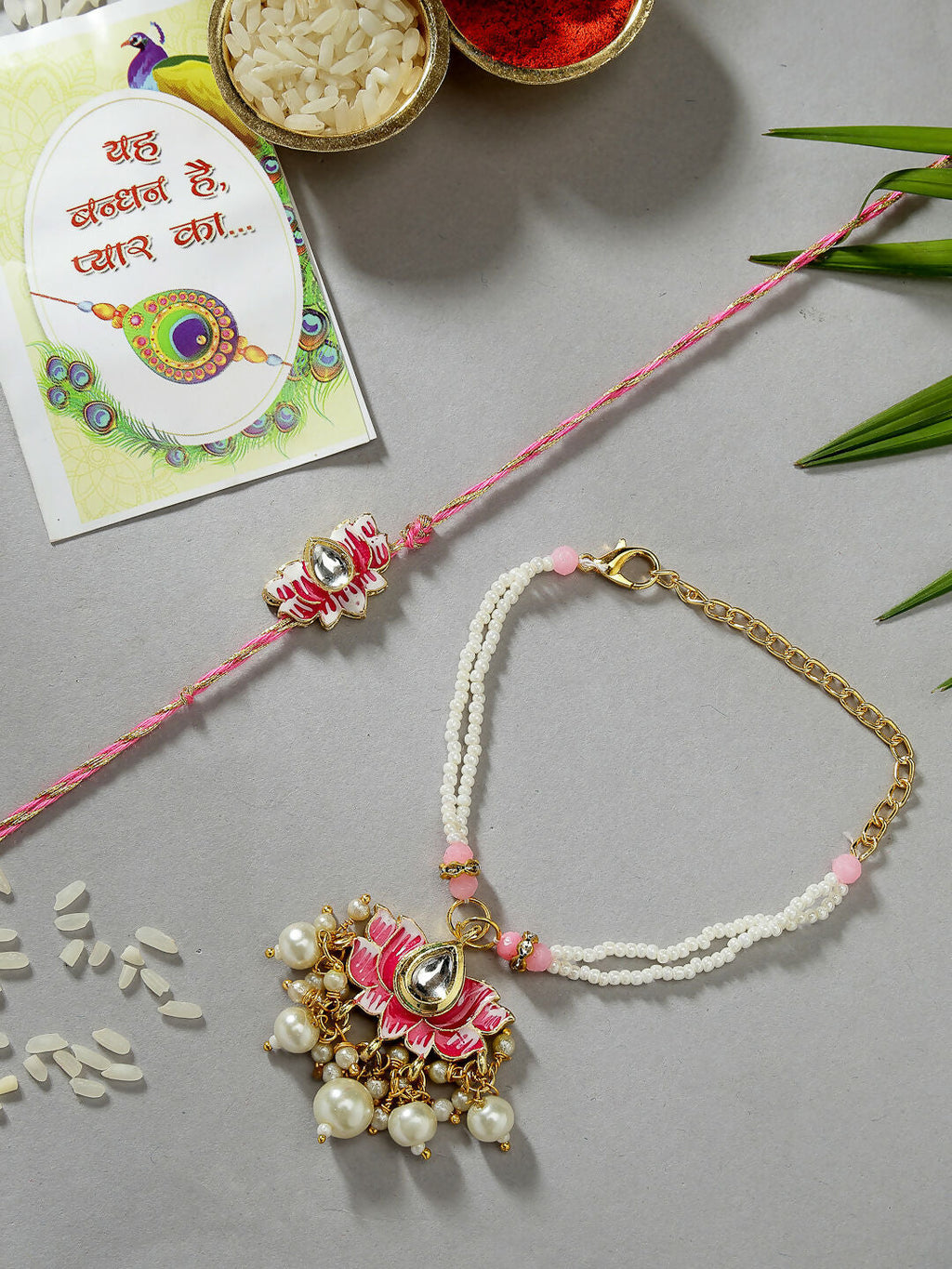 NVR Women & Men Set of 2 Pink Lotus Shape Kundan-Studded & Beaded Handcrafted Wraparound Rakhi Set With Roli Chawal