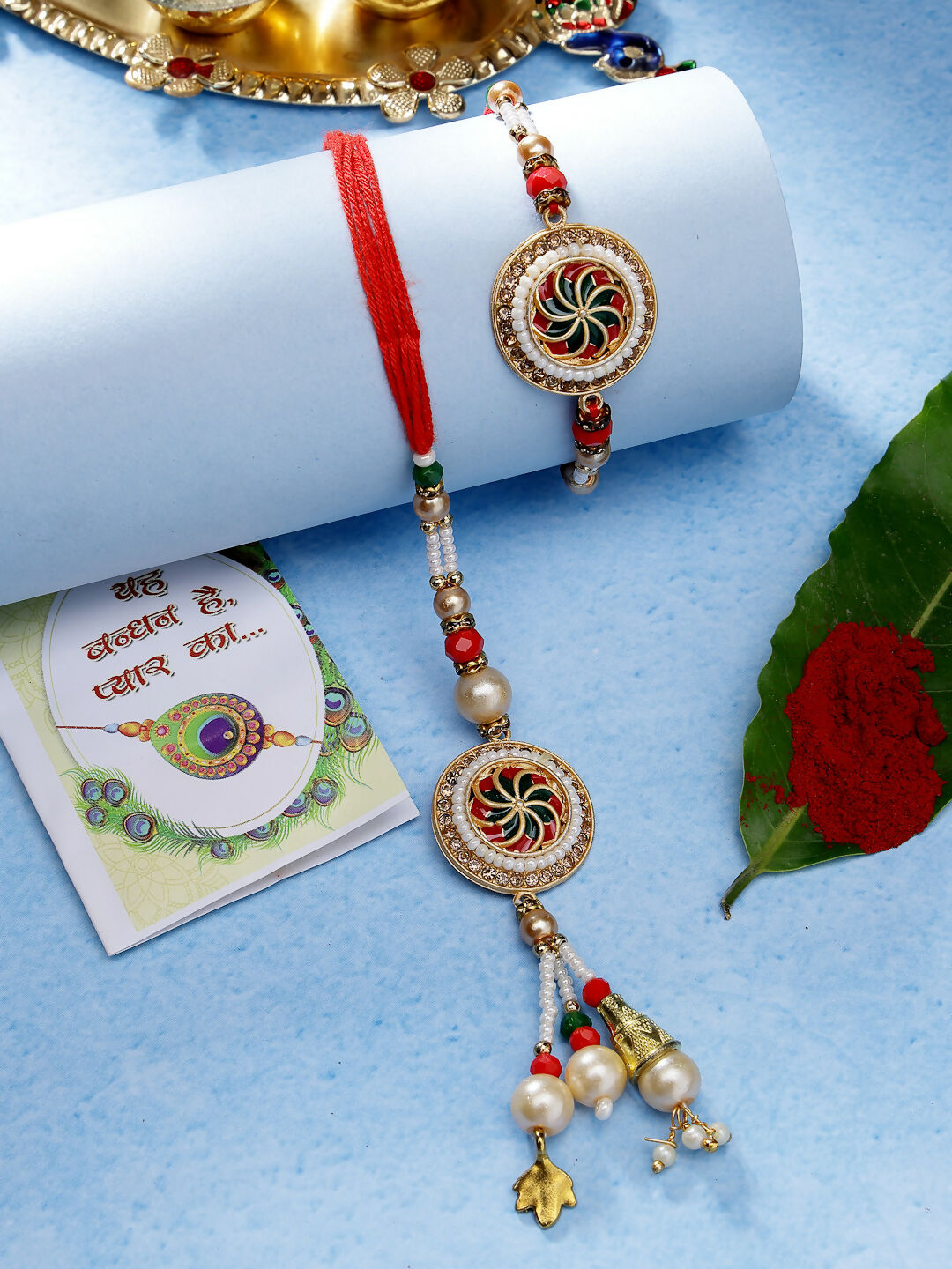NVR Women & Men Set of 2 Gold-Toned Stone-Studded & Beaded Bhaiya Bhabi Rakhi With Roli Chawal & Chocolate